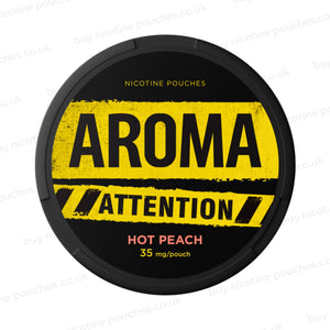 Black nicotine pouch container with yellow Aroma Attention Hot Peach branding on a white background.