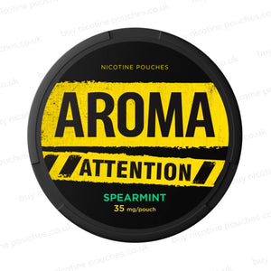 Black nicotine pouch container with yellow and green Aroma Attention Spearmint branding on a white background.