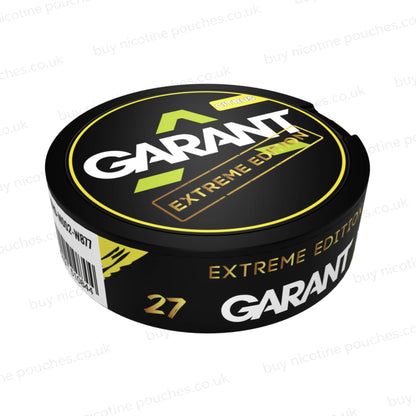 Angled shot of a black nicotine pouch container with yellow, white and gold 'GARANT EXTREME EDITION CITRUS' branding on a white background.