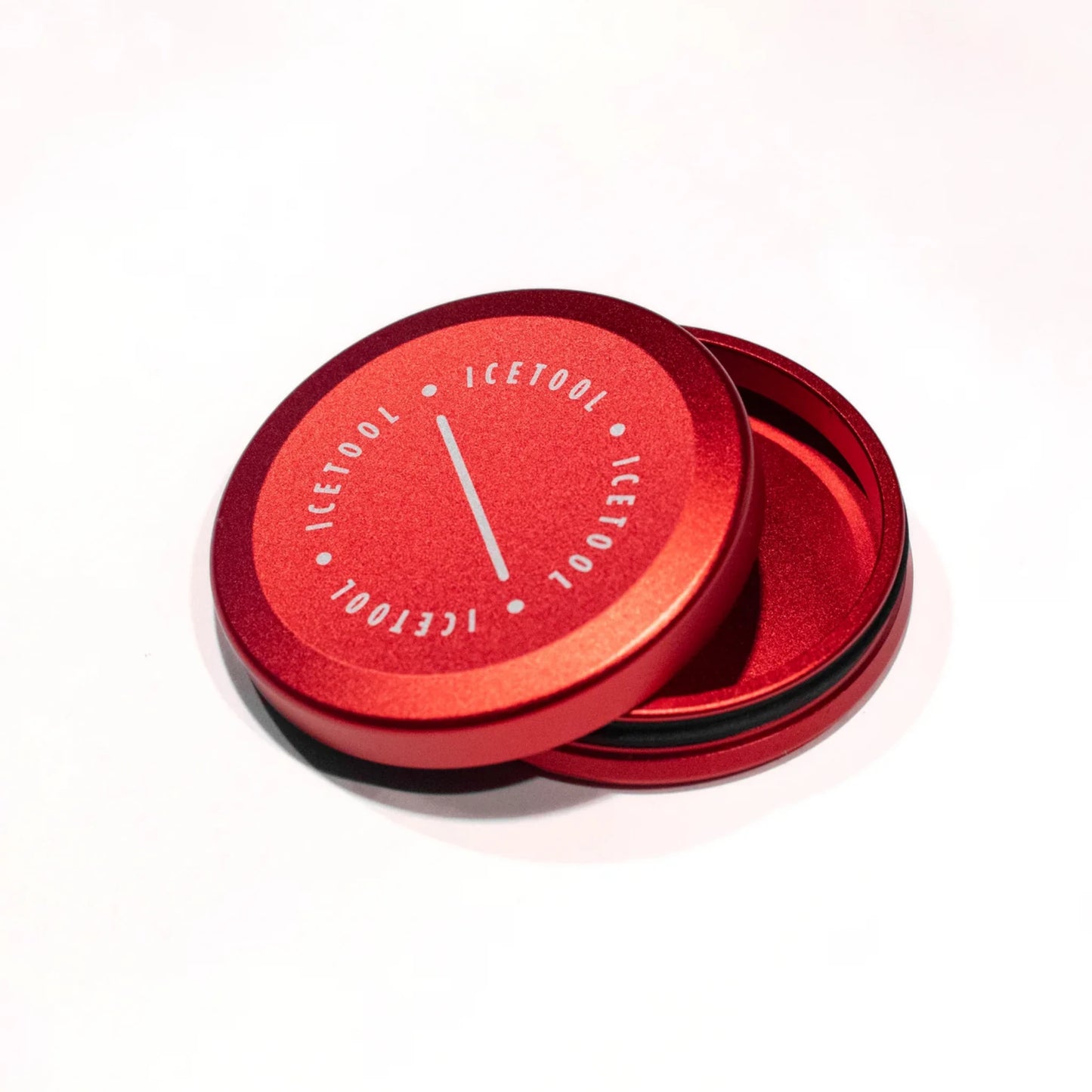 Open red circular metallic container with Icetool branding on a white background.