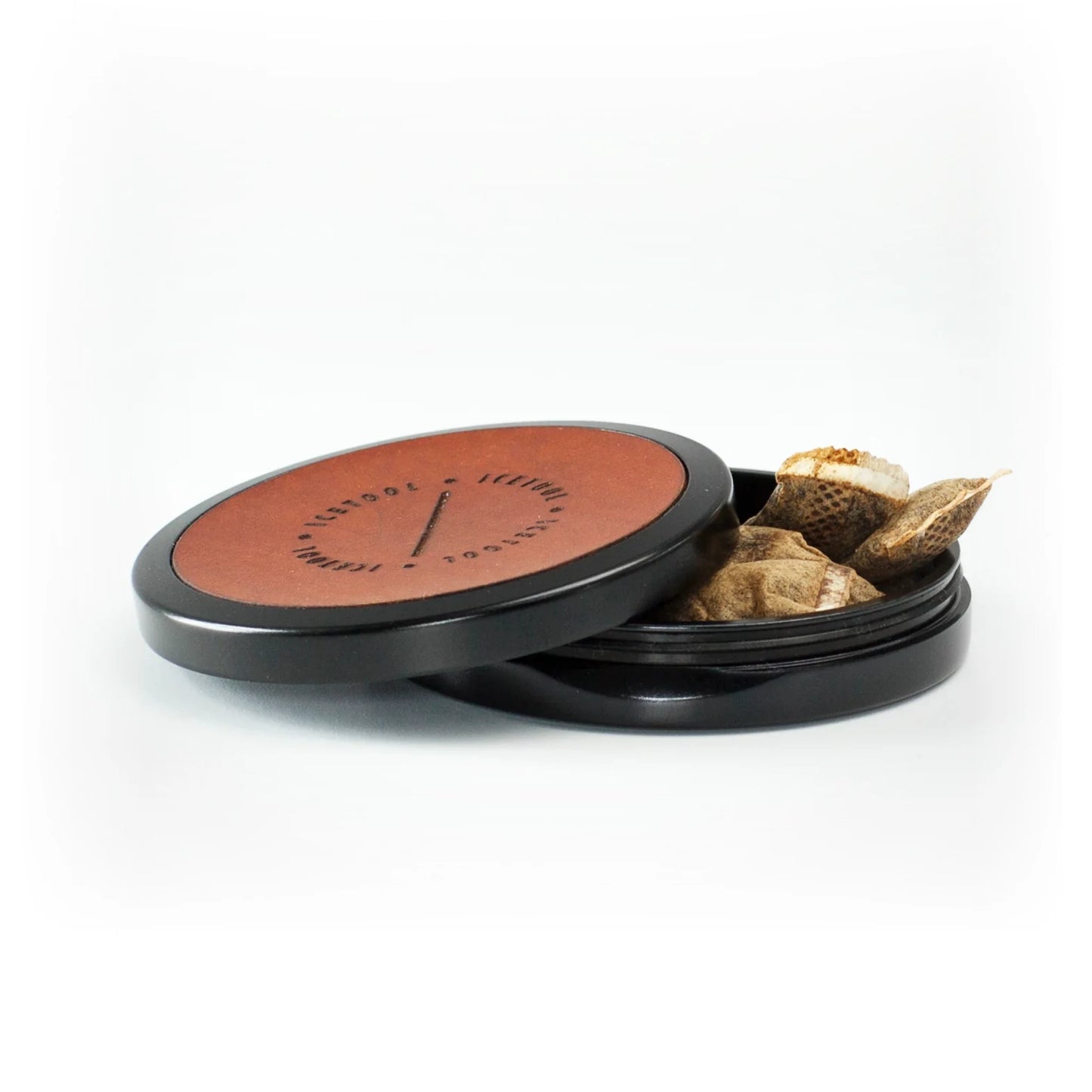 Open brown and black container with Icetool branding, showing nicotine pouches stored inside.