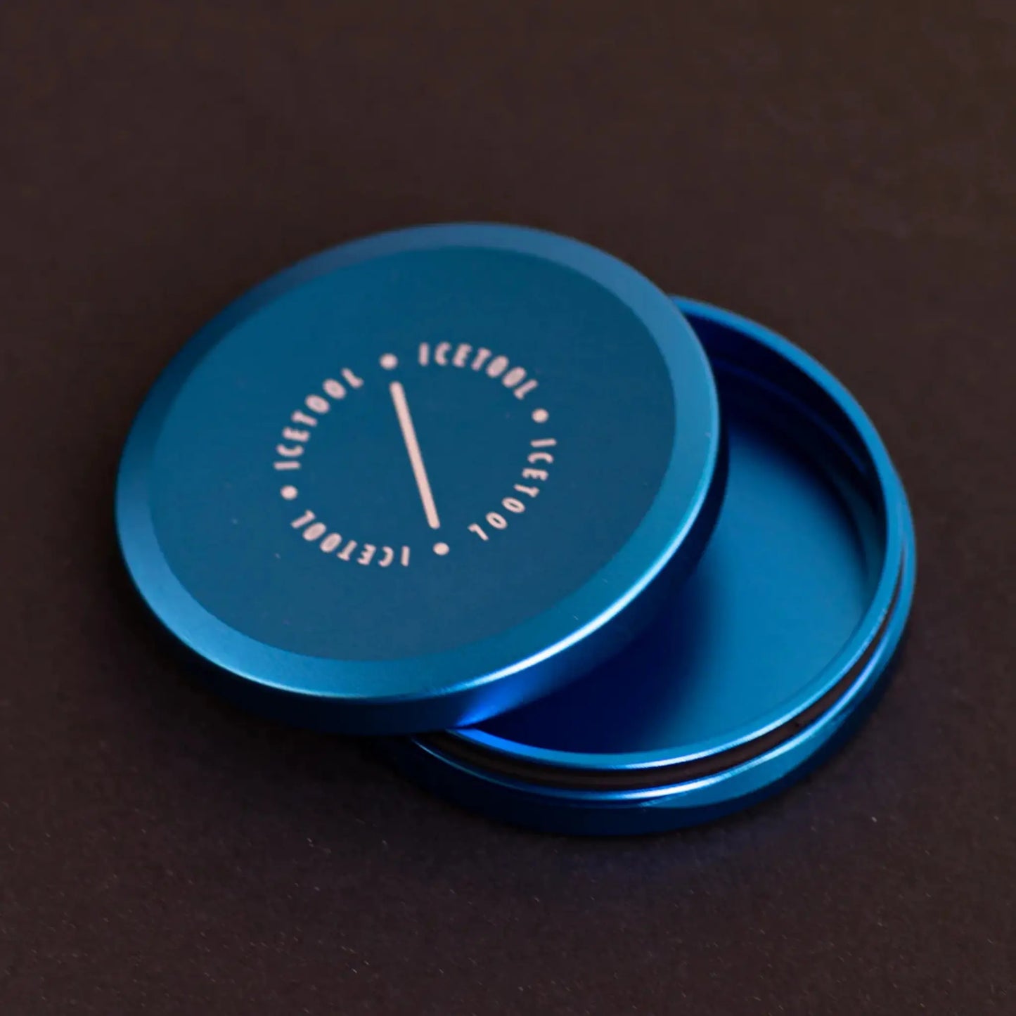 Open metallic circular container with Icetool branding on a dark grey background.