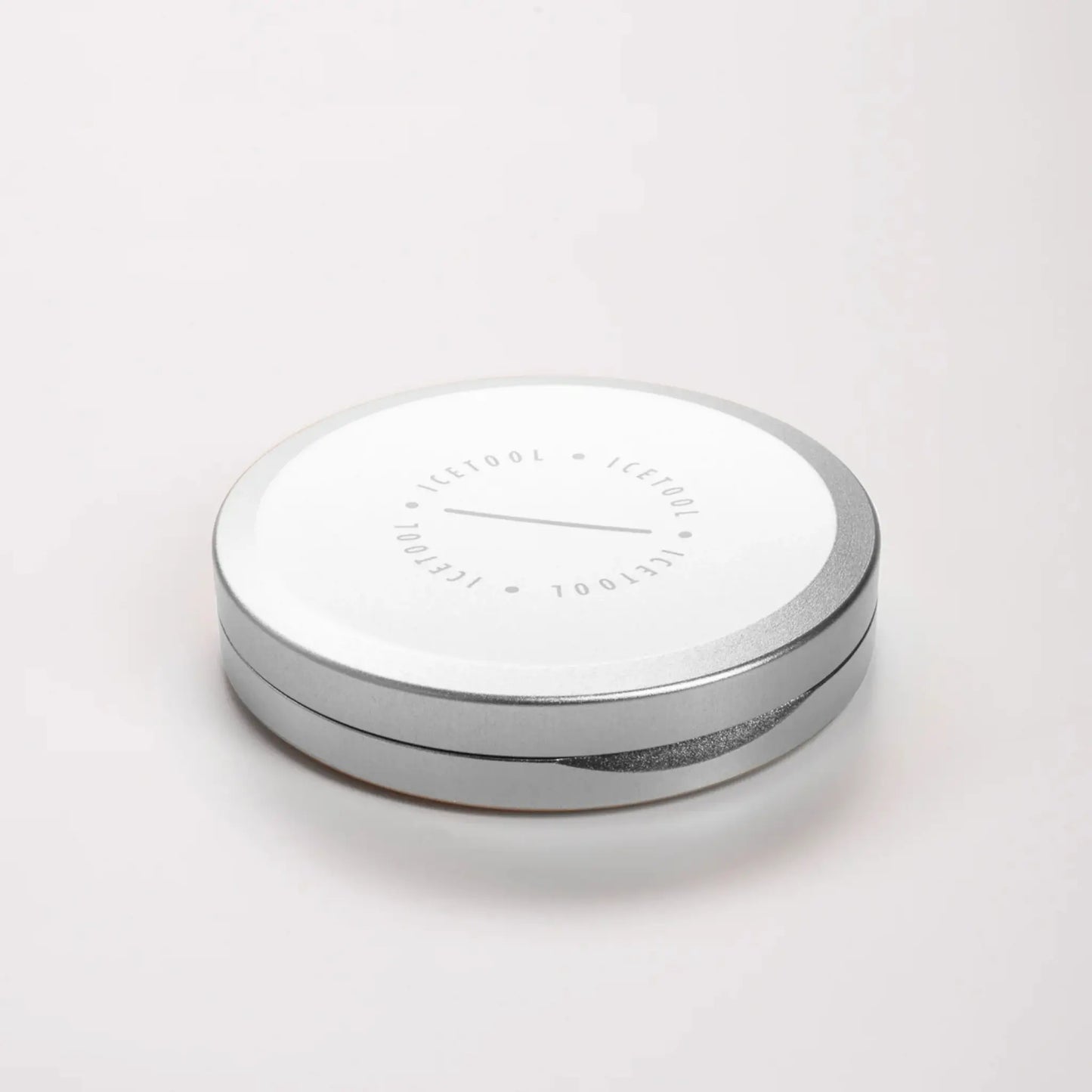 Angled shot of a silver circular container with Icetool branding on a grey background.