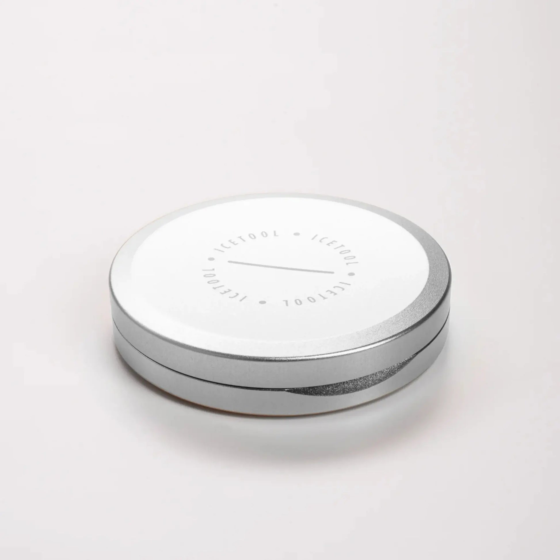 Angled shot of a silver circular container with Icetool branding on a grey background.