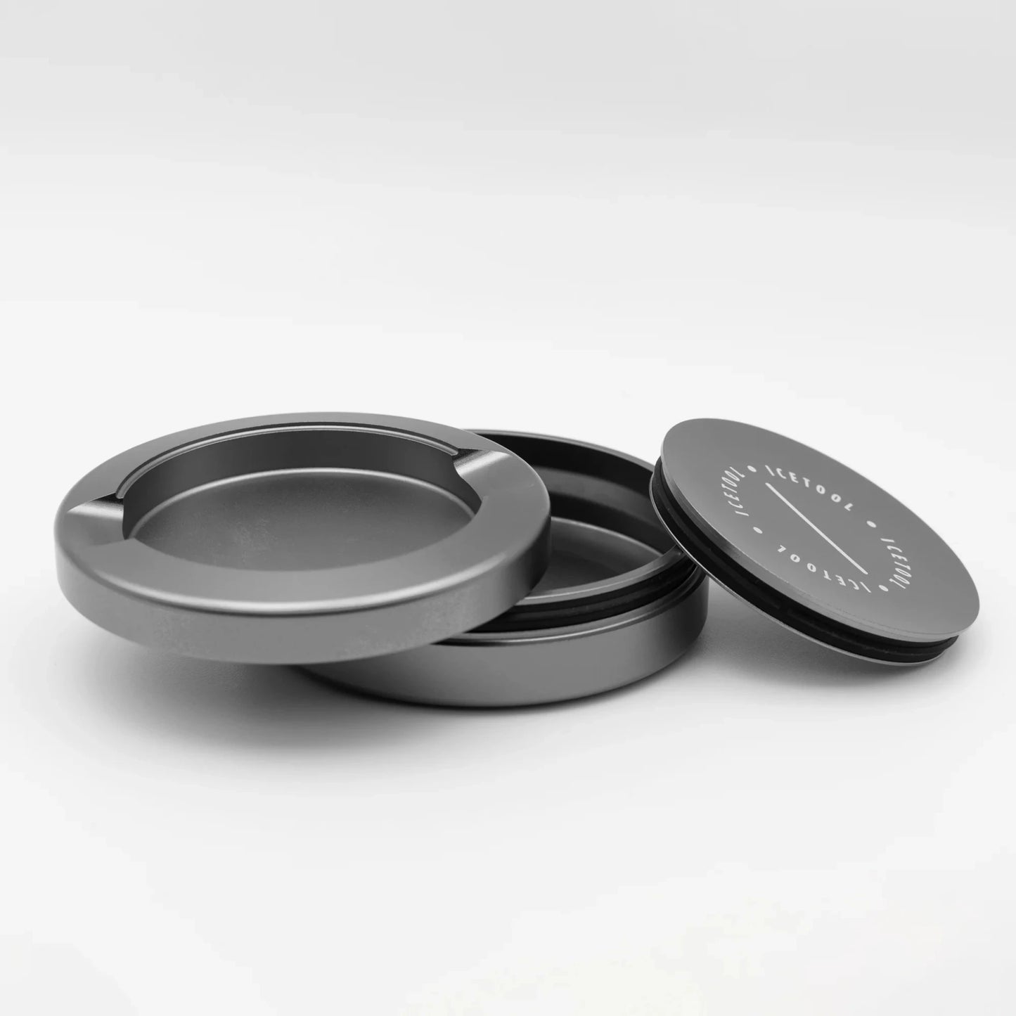 Disassembled round metallic container with 3 sections with Icetool branding, on a white background.