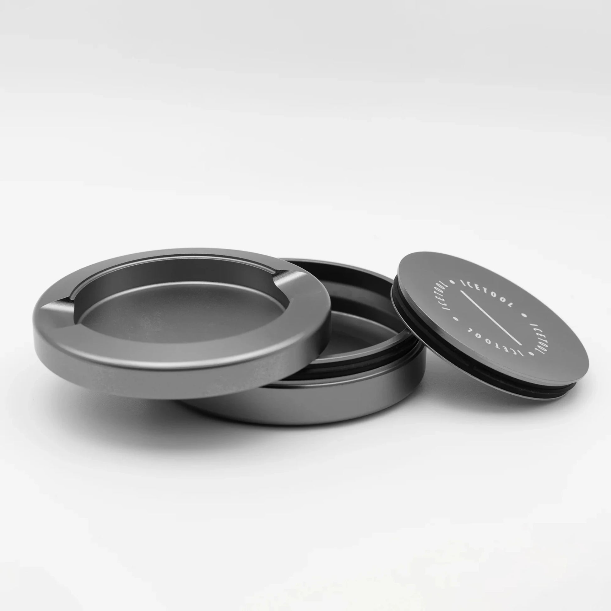 Disassembled round metallic container with 3 sections with Icetool branding, on a white background.