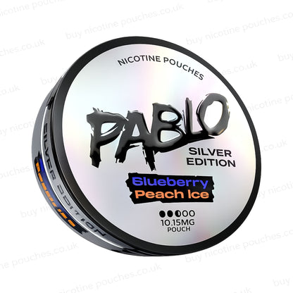 Angled shot of a nicotine pouch tub with 'PABLO Silver Edition Blueberry Peach Ice' branding on a white background.