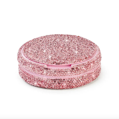 Angled product photo of a pink nicotine pouch tub covered in rhinestones.