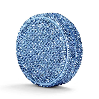 Angled shot of a circular container covered in blue rhinestones on a white background.