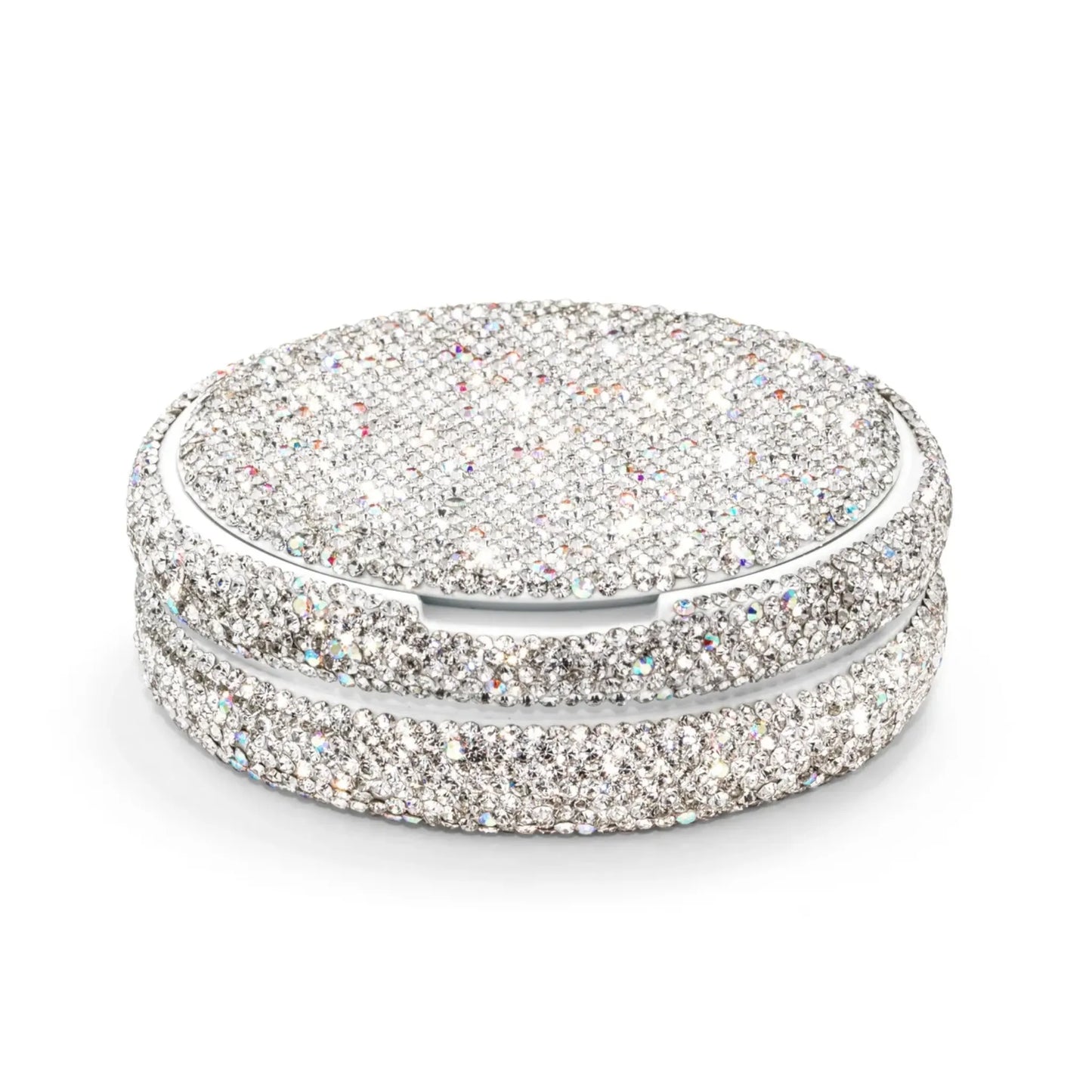 Angled shot of a circular container covered in silver rhinestones on a white background.