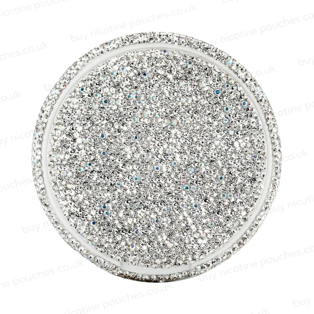 Silver circular container covered in rhinestones on a white background.